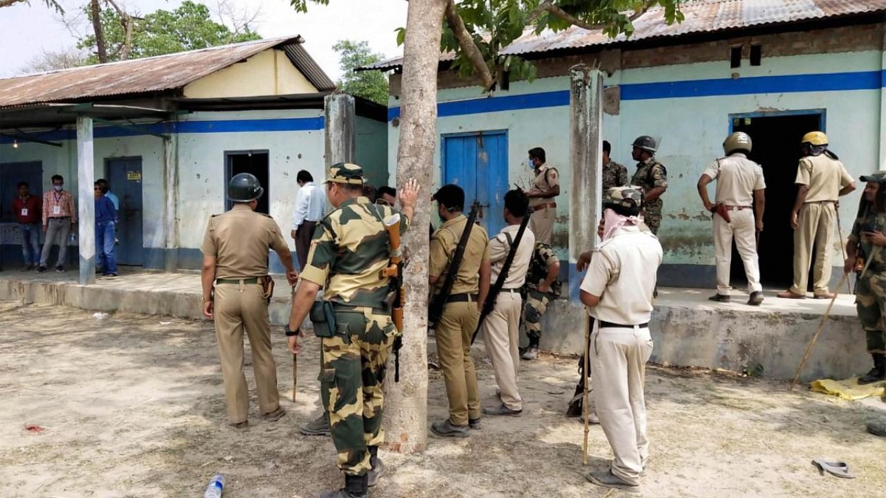 Security personnel keep vigil at a polling station after Election Commission ordered of stopping the voting exercise at polling station number 126 in Sitalkuchi, where clashes erupted. Credit: PTI Photo