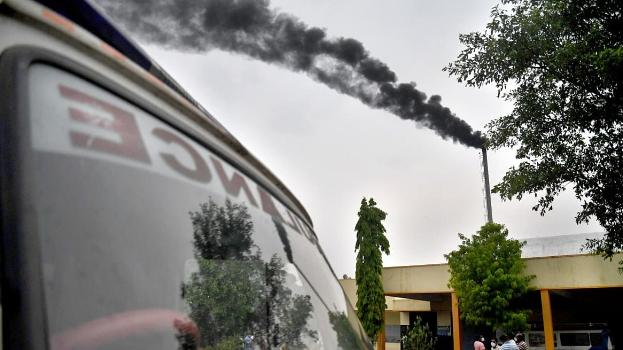 Black smoke covers the sky as several ambulances queue up outside Medi Agrahara Crematorium, one of the Covid-19 designated crematorium in Bengaluru. Credit: DH Photo