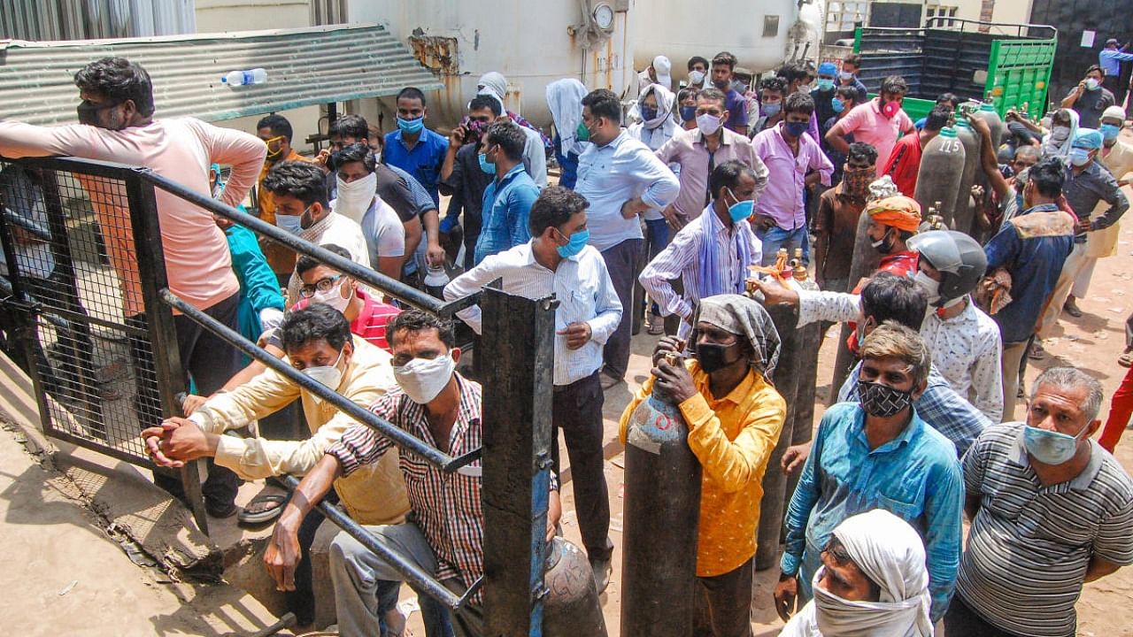  Crowd outside a medical oxygen refilling plant, in Kanpur. Credit: PTI Photo