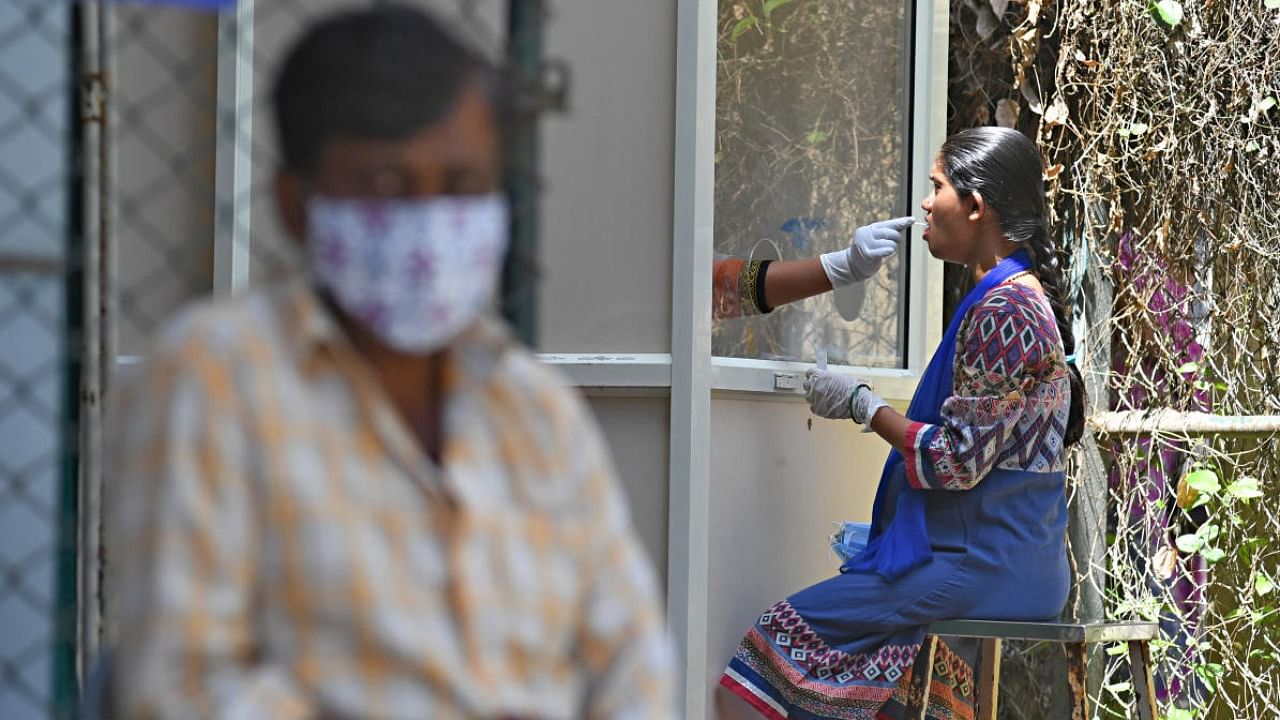 A healthcare worker conducts a Covid-19 test. Credit: DH Photo