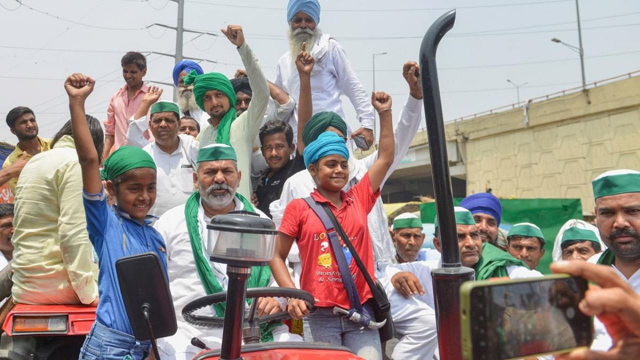  BKU spokesperson Rakesh Tikait rides a tractor during farmers' protest against three farm reform laws at Ghazipur border in New Delhi. Credit: PTI Photo