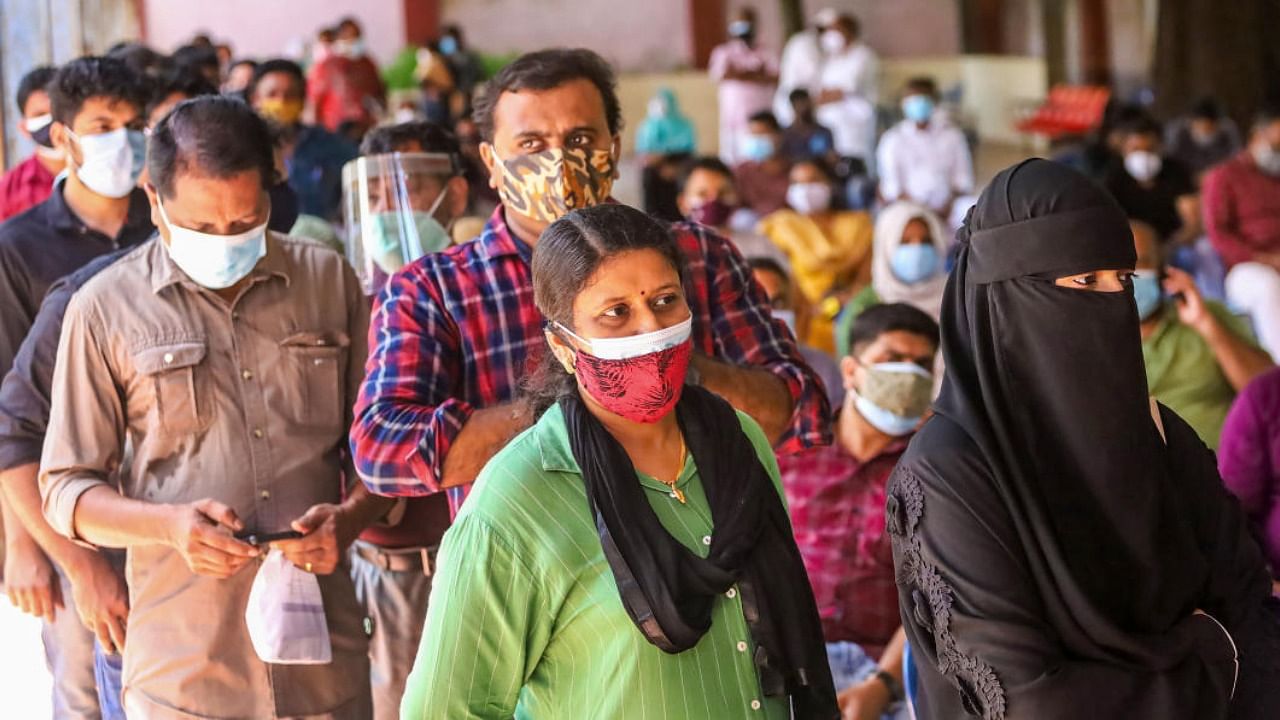 Beneficiaries wait to receive the Covid-19 vaccine at a vaccination camp, in Kozhikode. Credit: PTI Photo