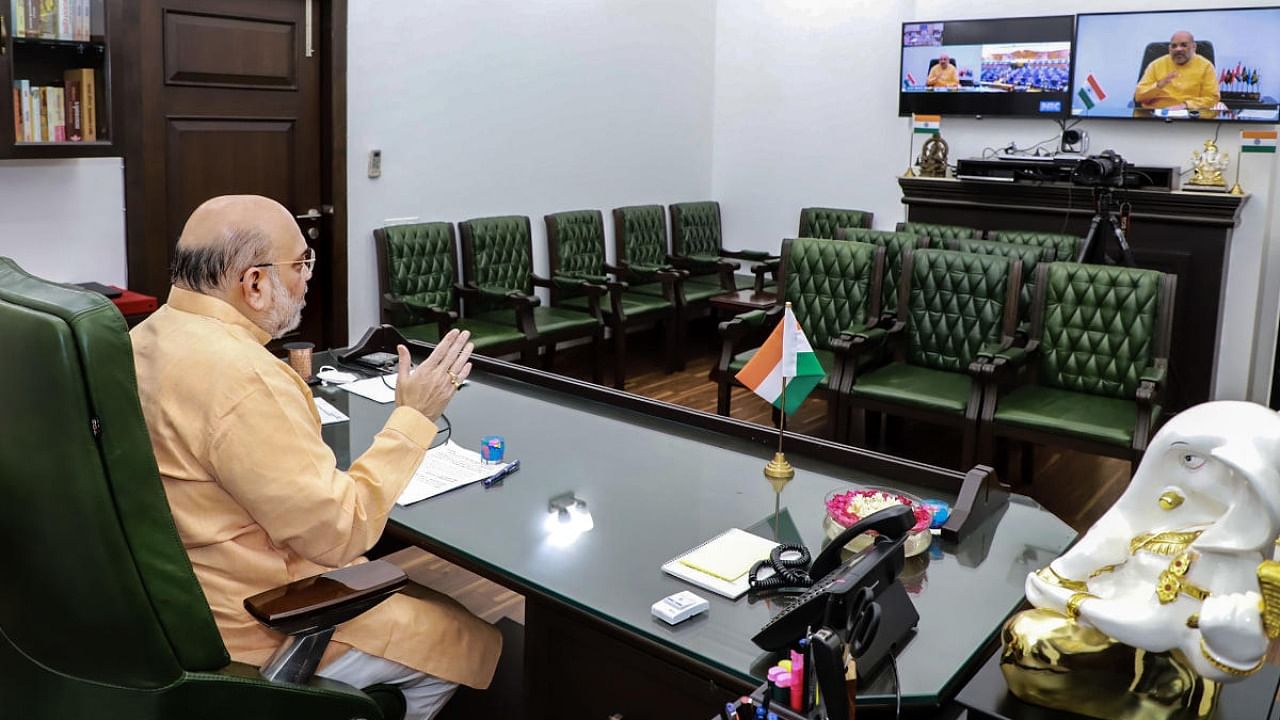 Union Home Minister Amit Shah interacts with the probationary officers of 72nd batch of Indian Police Service (IPS) through video conferencing, in New Delhi.Credit: PTI Photo