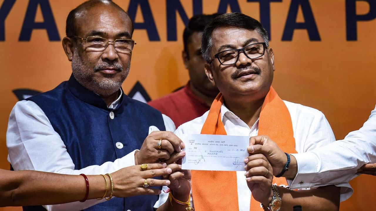 Former Manipur Congress chief Govindas Konthoujam joins BJP in the presence of Manipur Chief Minister N Biren Singh, in New Delhi. Credit: PTI Photo