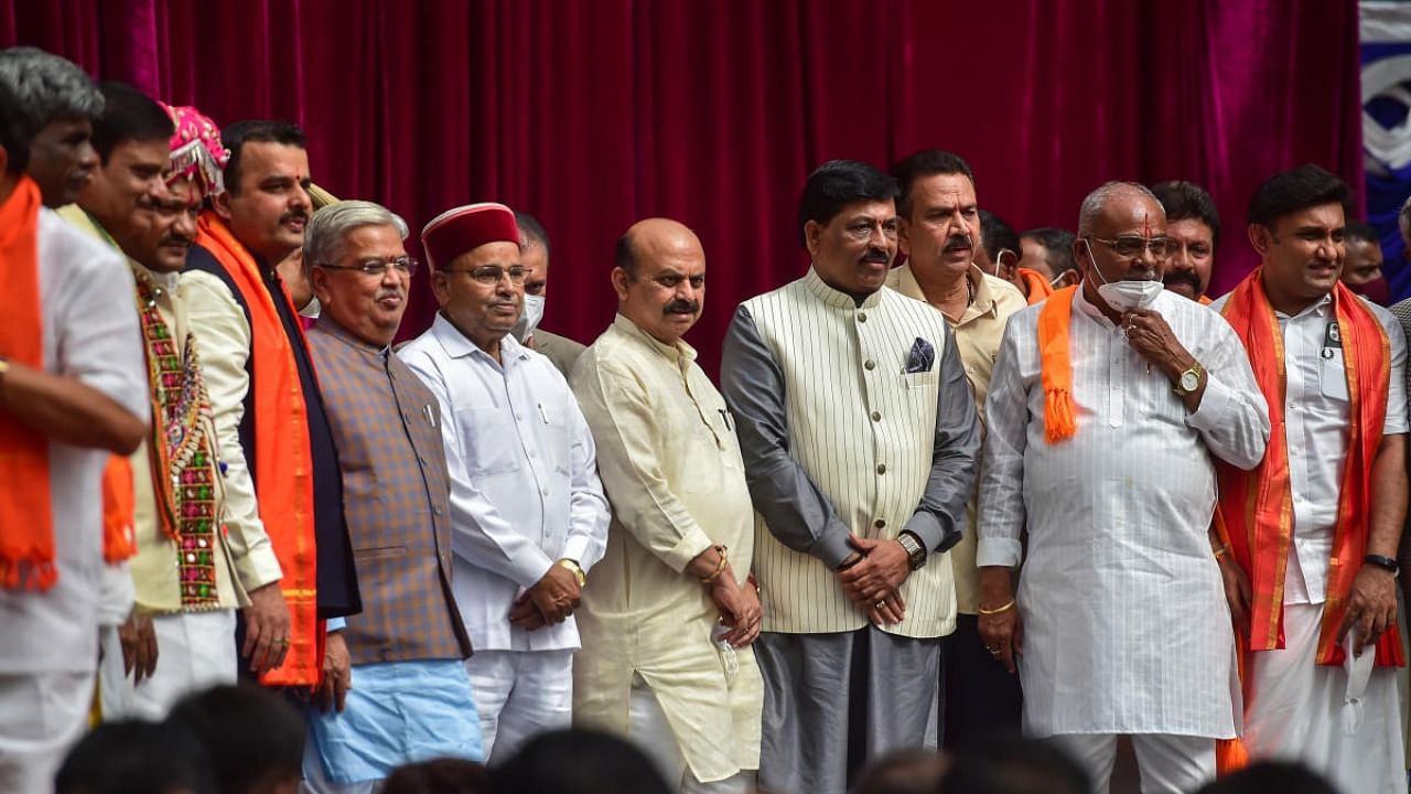 Karnataka Governor Thawar Chand Gehlot and Chief Minister Basavaraj Bommai with newly inducted ministers during swearing-in ceremony to form the Cabinet at Raj Bhavan in Bengaluru. Credit: PTI Photo