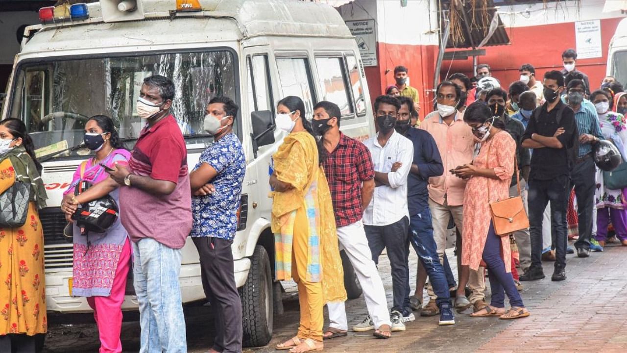 Beneficiaries wait in a queue to receive Covid-19 vaccine dose, at Eranamkulam General Hospital in Kochi. Credit: PTI Photo