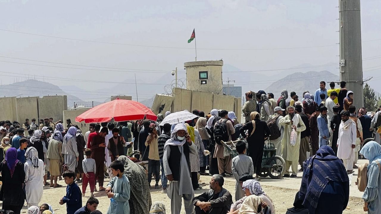 Hundreds of people gather outside the international airport in Kabul, Afghanistan. Credit: AP Photo