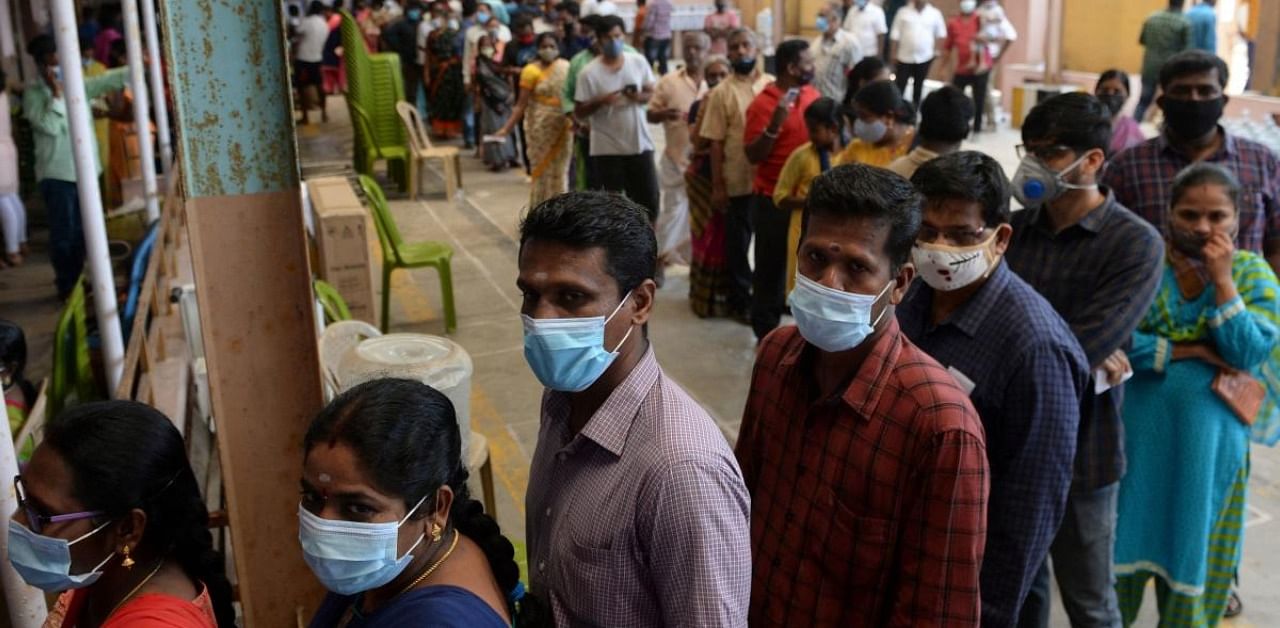 Voters stand in a line to cast their vote outside a polling station during Tamil Nadu state legislative election in Chennai. Credit: AFP Photo