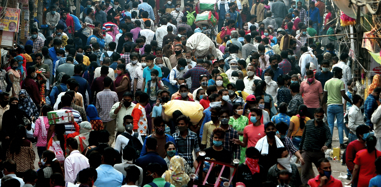 People, ignoring social distancing norms, visit a crowded Sadar Bazar market during the festive season, amid the ongoing coronavirus pandemic. Credits: PTI Photo