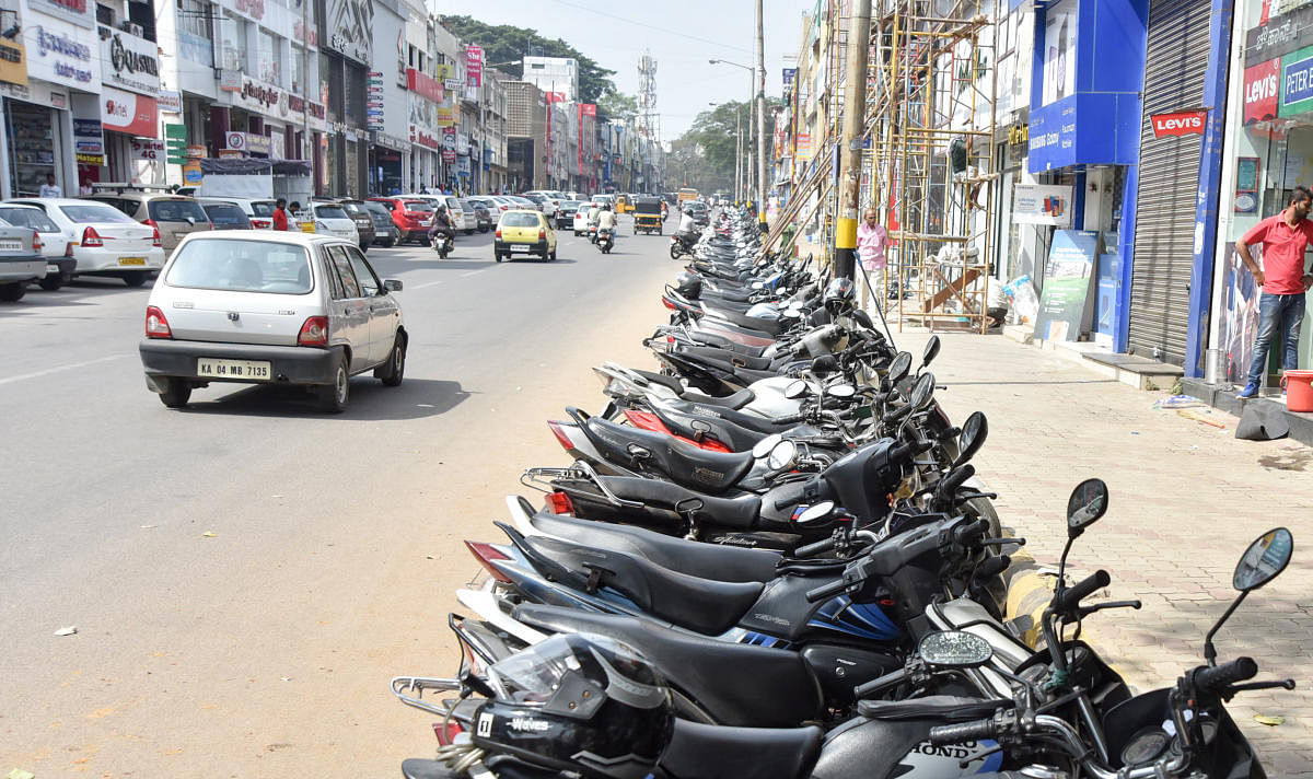Vehicles parked on D Devaraja Urs Road, in Mysuru. DH File Photo / Savitha B R