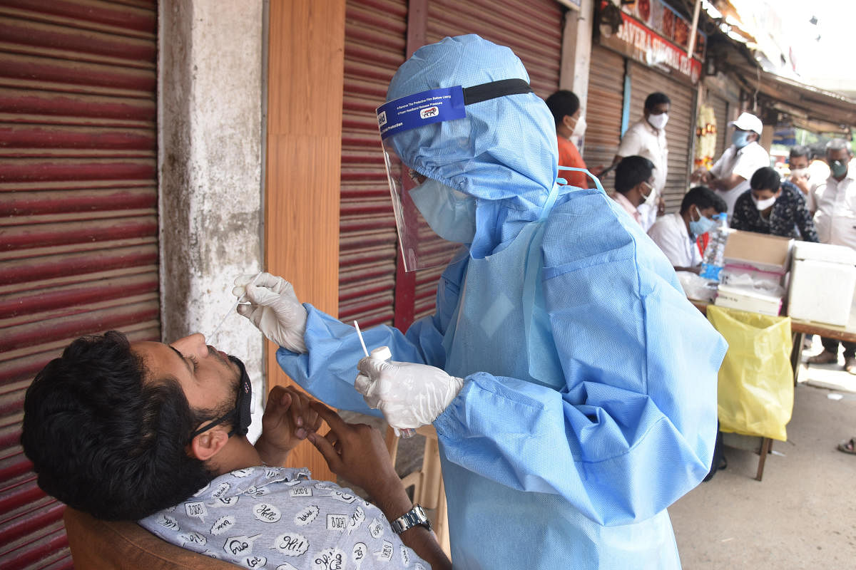 Swab tests at KR Market. Public health experts say extensive testing is paramount to fighting the pandemic, but people fear the social stigma that comes with testing positive. DH Photo by SK Dinesh