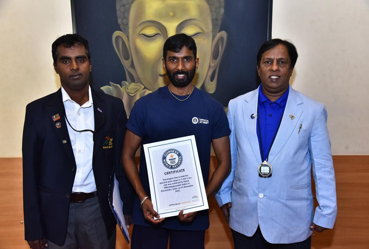 Vijesh Elikattepparambil (centre) recently entered the Guinness Book of World Records for holding the scorpion pose for two minutes and 14 seconds.