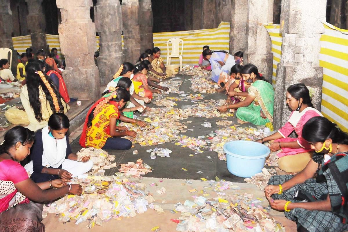 Volunteers count money at Srikanteshwara temple, in Nanjangud, Mysuru district.