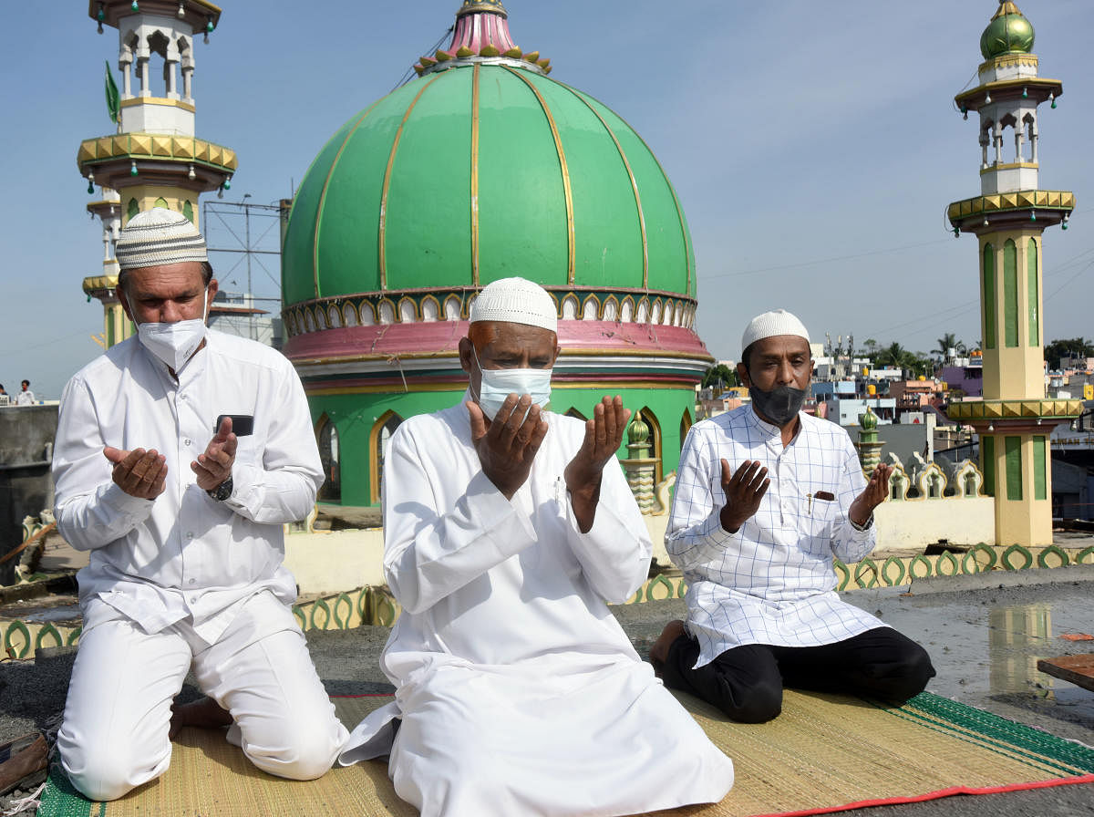 Members of the Muslim community offer prayers on the terrace of a building on the occasion of Eid-ul-Fitr on Friday. DH Photo/Anup Ragh T