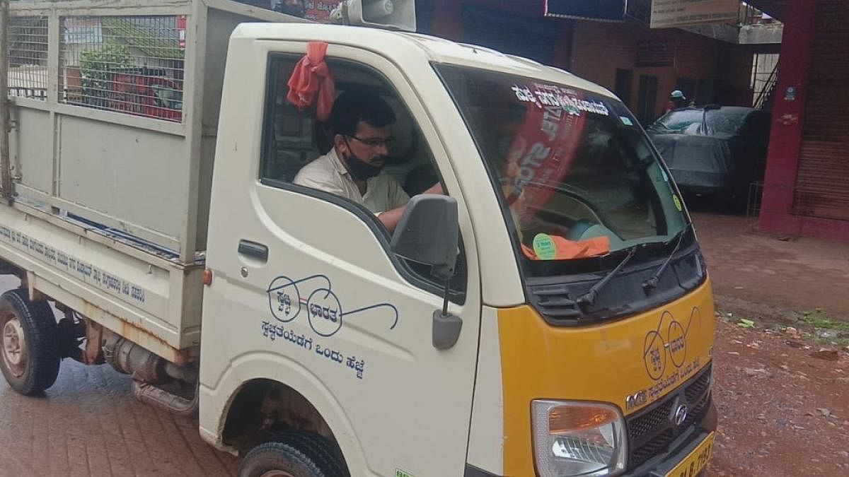 Town Panchayat president Vinaykumar drives a garbage truck in Sullia on Friday. Credit: DH 
