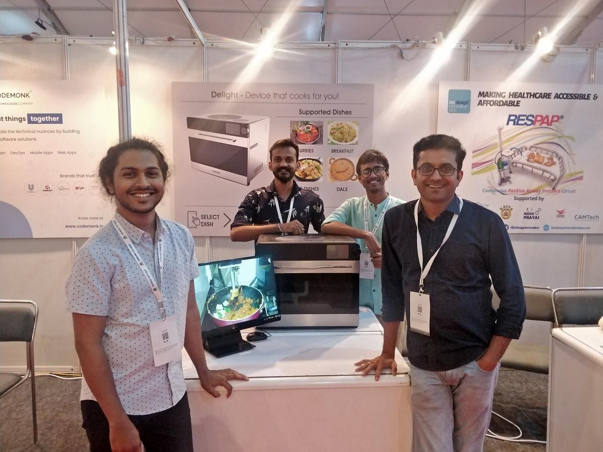 Pranav, Amit, Sudeep and Yatin Varachhia (extreme right) are part of the team that developed Nosh, a robot that specialises in Indian dishes.