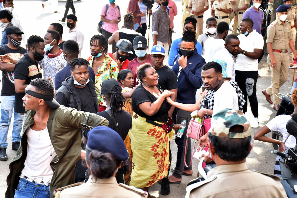 The death of 27-year-old Joan alias Joel Shindani Malu, a Congolese national, sparked protests from members of the African community on Monday. A video of the police caning a protester in front of the J C Nagar police station went viral. DH Photo by B K Janardhan
