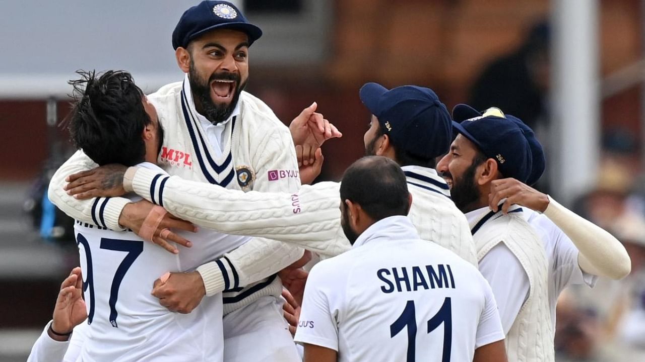 India's captain Virat Kohli (2L) celebrates with India's Ishant Sharma (L) and teammates after the successful appeal for the wicket of England's Jonny Bairstow on the fifth and final day of the second cricket Test match between England and India at Lord's cricket ground in London on August 16, 2021. Credit: AFP Photo