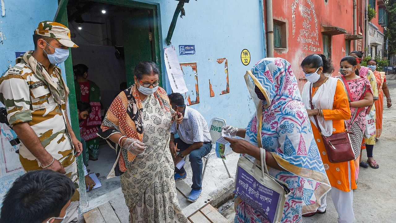 Voters stand in a queue outside a polling station to cast their votes during the last phase of West Bengal Assembly Elections, in Kolkata. Credit: PTI Photo