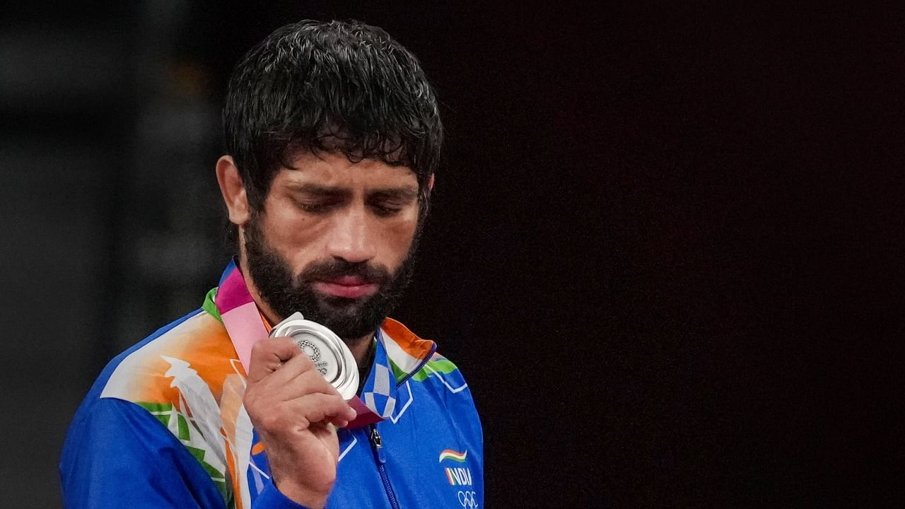 Ravi Dahiya holds his silver medal. Credit: PTI Photo