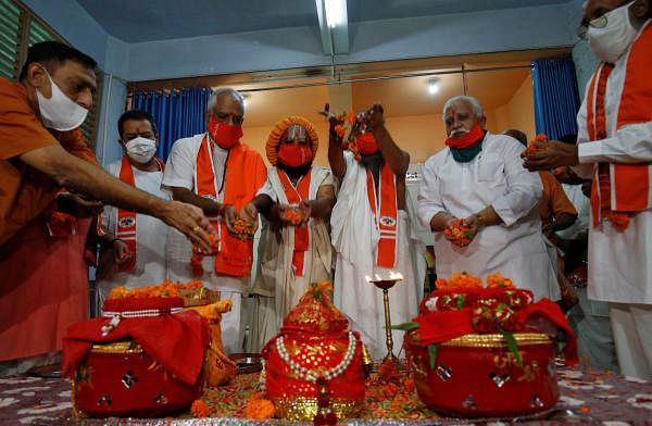 Hindu priests and supporters of the Vishva Hindu Parishad (VHP), a Hindu nationalist organisation, perform rituals next to pots filled with holy water and soil which they brought from various Hindu religious places, before taking the pots to the northern town of Ayodhya for a stone laying ceremony in the Ram Temple, in Ahmedabad, India July 27, 2020. Credit: Reuters