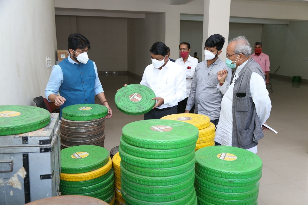 Chairman Suneel Puranik (in blue) with old film reels brought in for restoration at the academy in Nandini Layout.