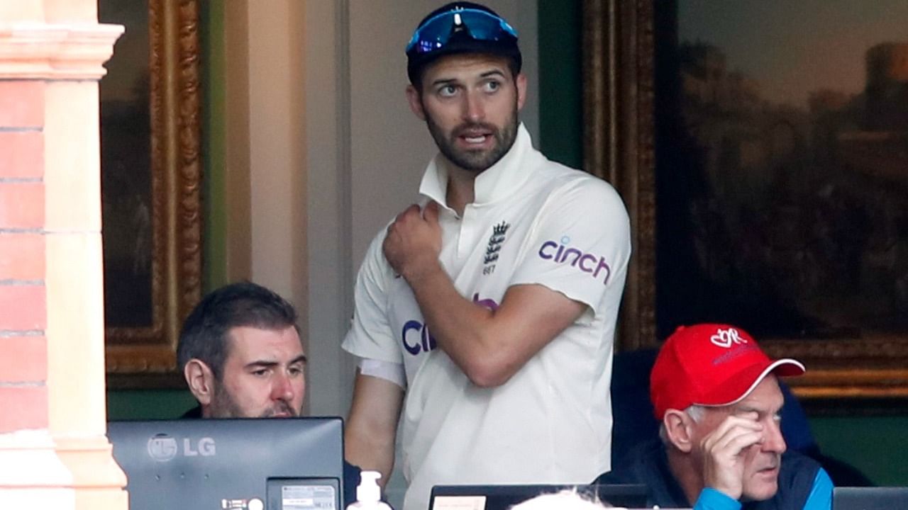 England's Mark Wood in the dressing room after leaving the field of play with an injury. Credit: Reuters Photo
