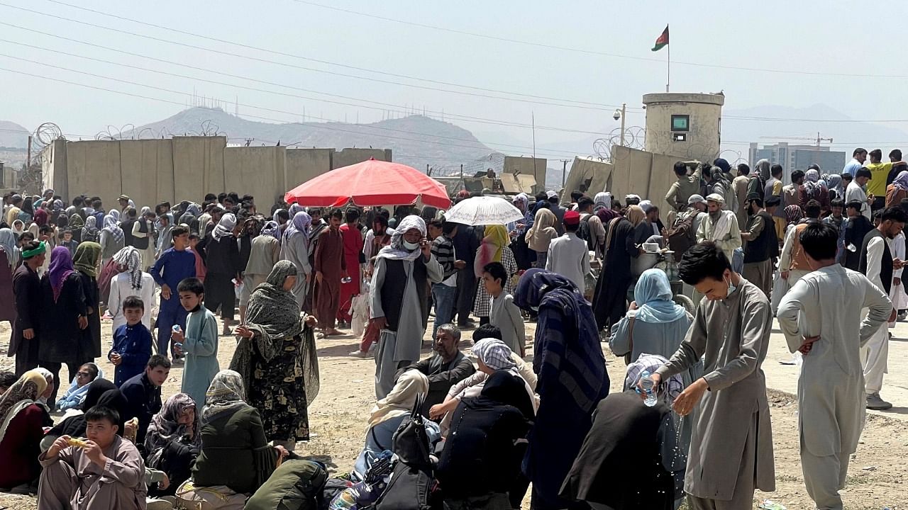 People wait outside Hamid Karzai International Airport in Kabul. Credit: Reuters Photo