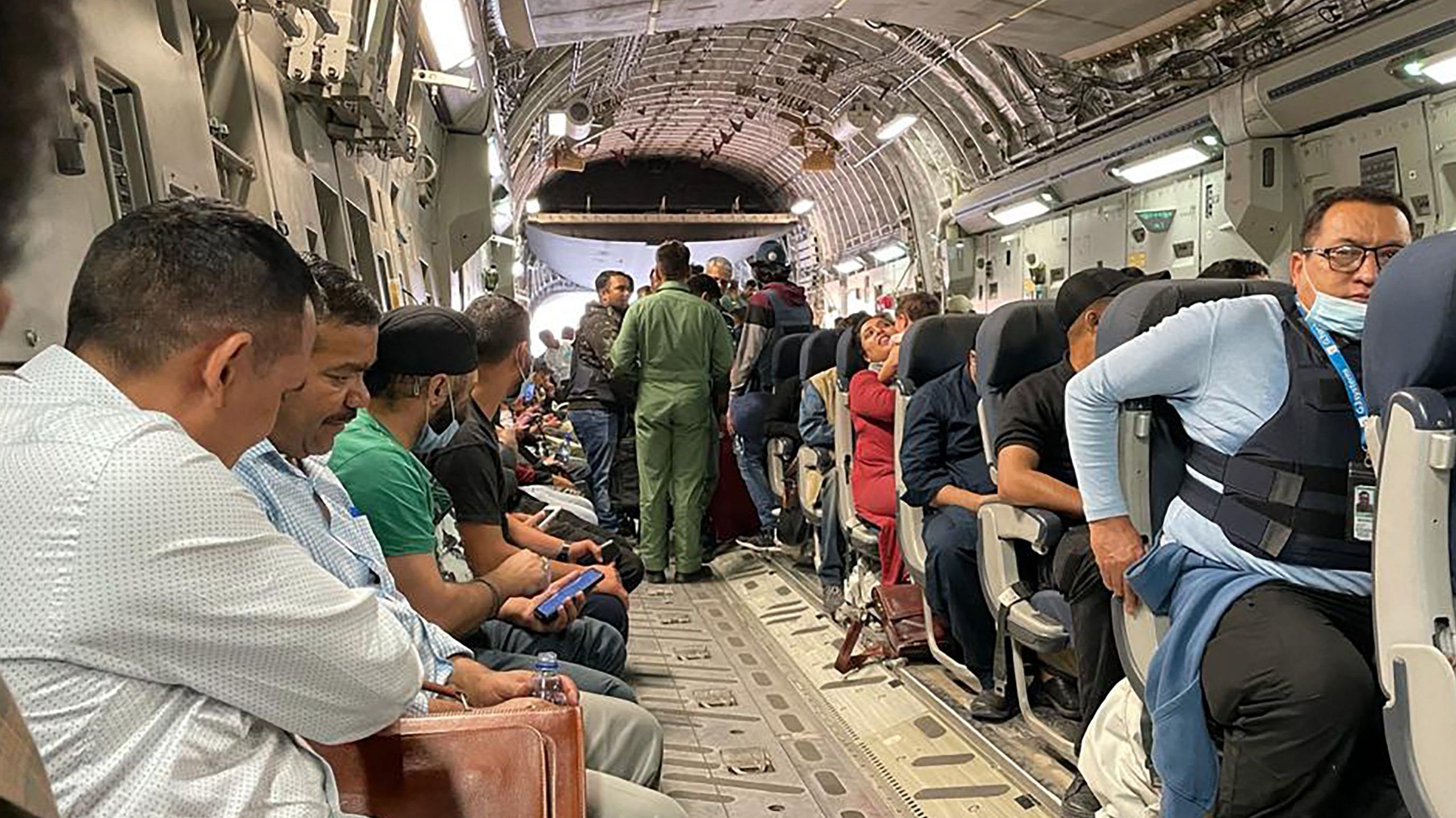 ndian Nationals sit aboard an Indian military aircraft at the airport in Kabul. Credit: AFP