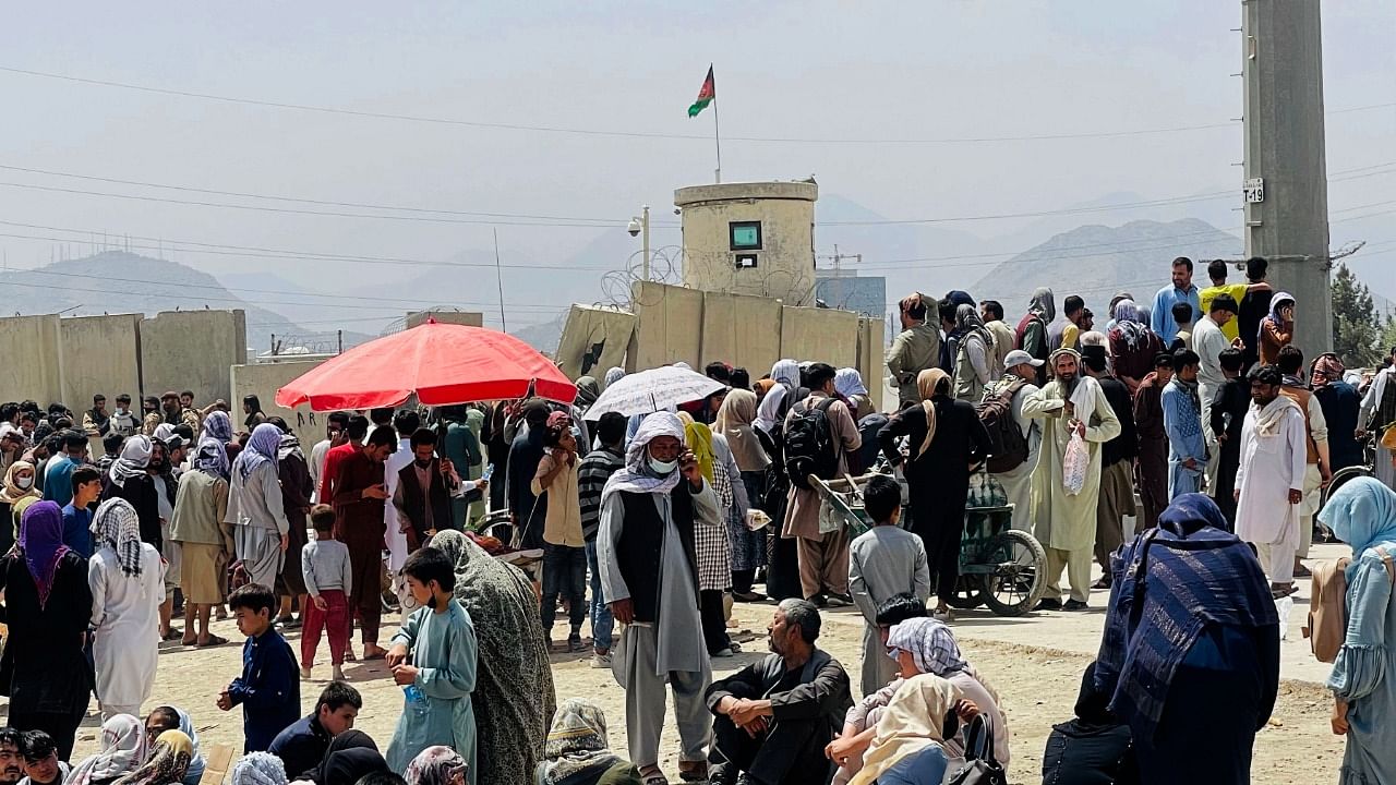 Hundreds of people gather outside the Hamid Karzai International Airport in Kabul, Afghanistan. Credit: AP/PTI Photo