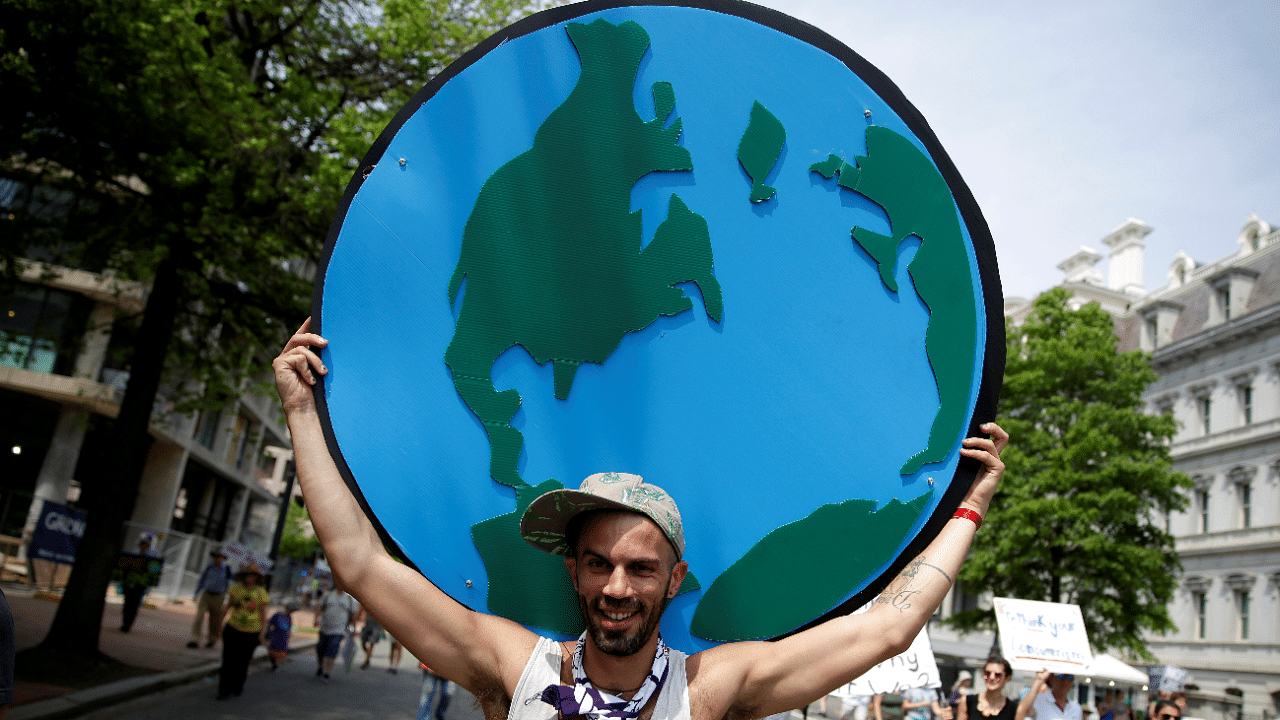 A protester carries a sign depicting the earth during the Peoples Climate March near the White House in Washington. Credit: Reuters Photo