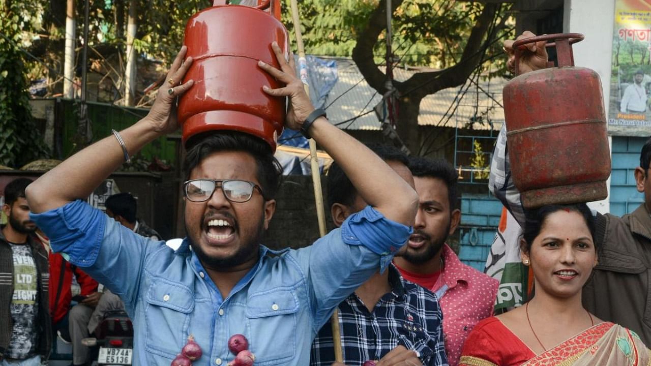 Indian activists of Congress party wear garlends made of onions as they protest against the price rise of onions, vegetables and the LPG gas cylinder. Credit: AFP Photo