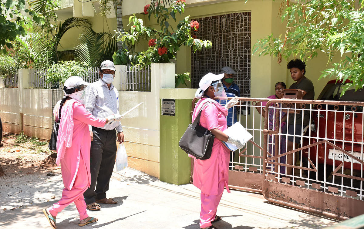 Asha workers visit houses in Gokulam of Mysuru city, on Tuesday, to document the health condition of the residents.