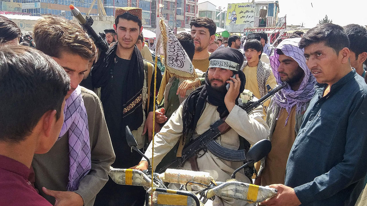 A Taliban seen surrounded by locals in an Afghan town. Credit: AFP Photo