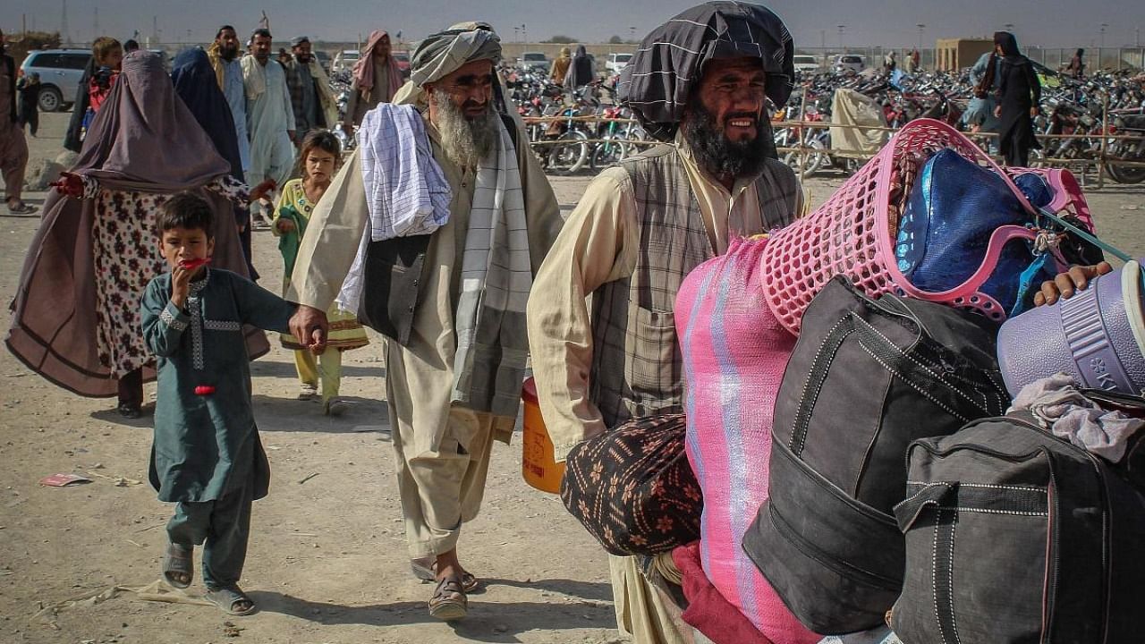 Afghan nationals arrive at the Pakistan-Afghanistan border crossing point in Chaman. Credit: AFP Photo