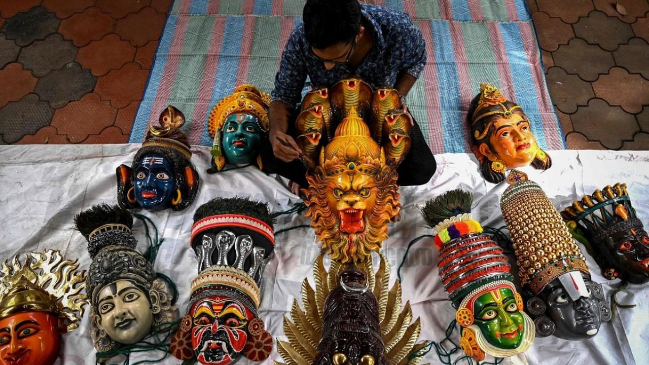 An artisan prepares face masks resembling various Hindu deities for Kummattikali which is a form of colourful mask dance as a part of Onam festival celebrations in Kerala. Credit: AFP Photo