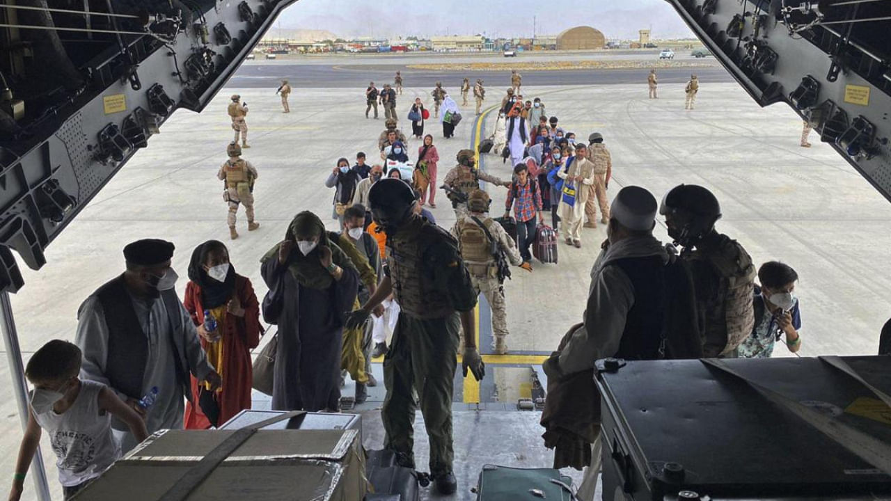 In this photo provided by the Spanish Defence Ministry and taken in Kabul, Afghanistan, people board a Spanish airforce A400 plane as part of an evacuation plan at Kabul airport in Afghanistan. Credit: AP Photo