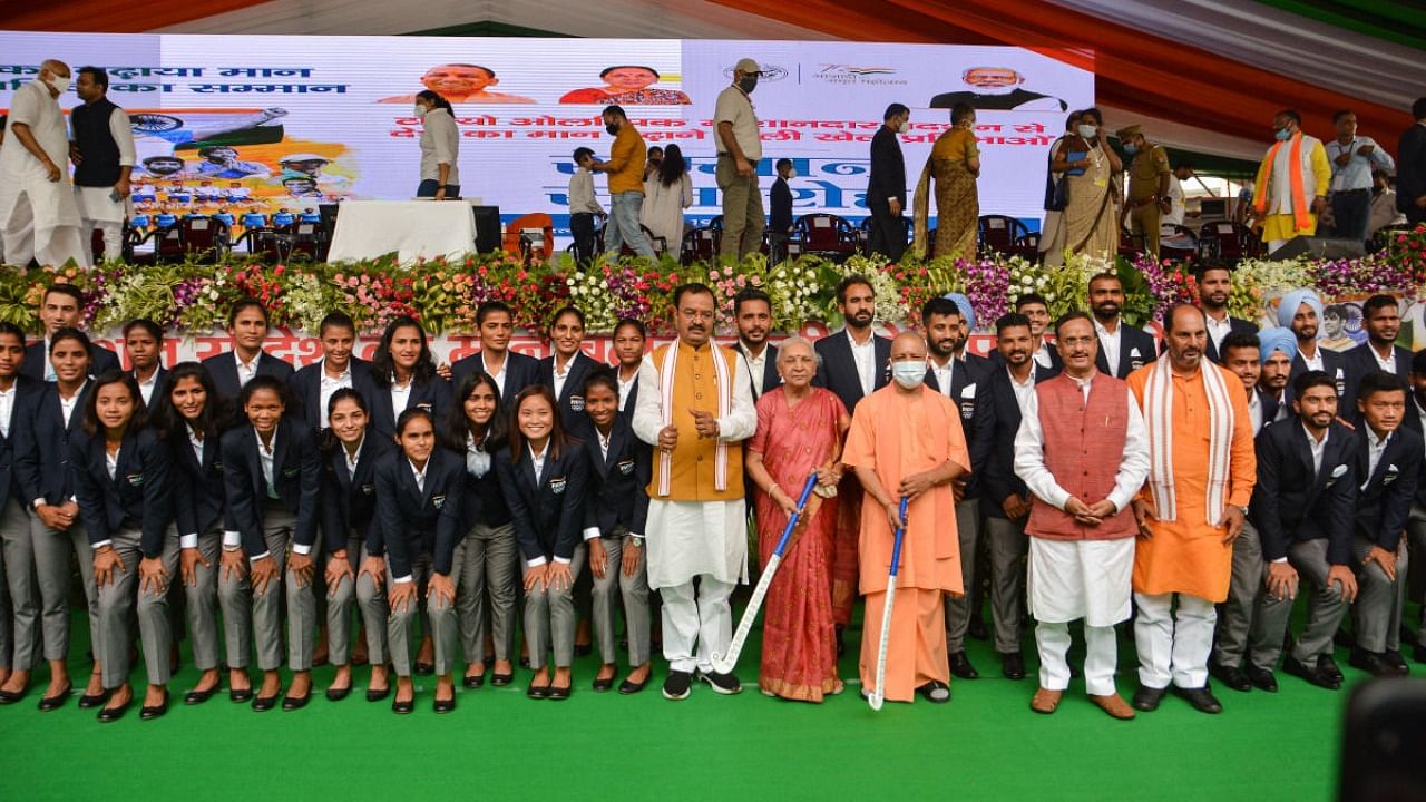 UP Governor Anandiben Patel and Chief Minister Yogi Adityanath with Indian men's and women's hockey teams in group photo during a feliciation ceremoney at Ekana Stadium in Lucknow. Credit: PTI Photo