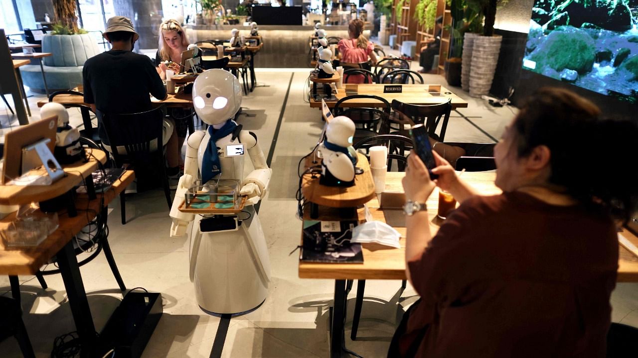A humanoid robot delivers drinks to customers at the Dawn Cafe in Tokyo. Credit: AFP Photo