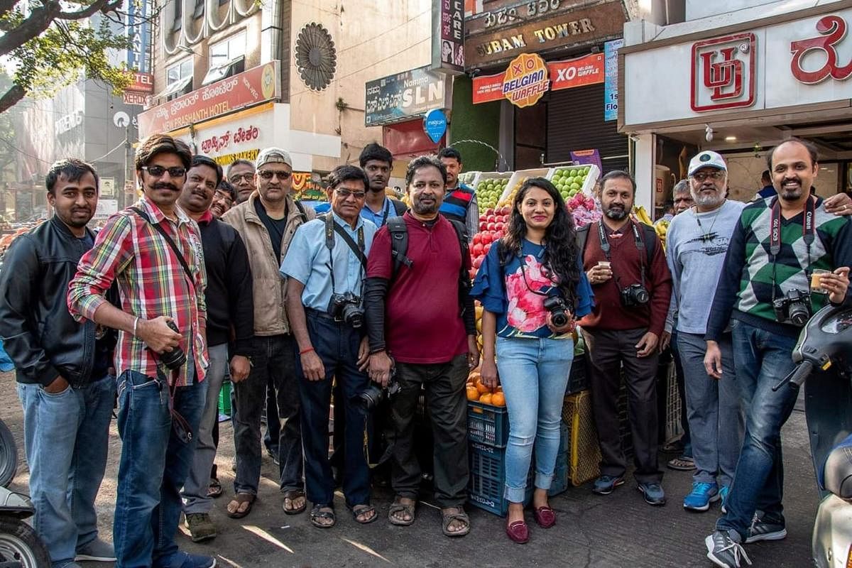 Manju Vikas Sastry V, secretary of the Youth Photographic Society (extreme right), with members in the course of a street photography workshop at Gandhi Bazaar.