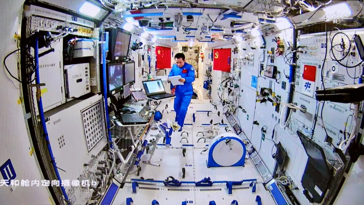 Chinese astronaut Tang Hongbo of the Shenzhou-12 mission works inside the core module Tianhe of the Chinese space station. Credit: Reuters Photo