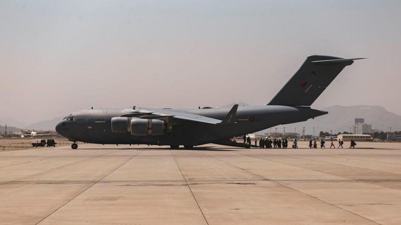 Evacuees board a Boeing C-17 Globemaster III during an evacuation at Hamid Karzai International Airport, Kabul, Afghanistan. Credit: Reuters Photo