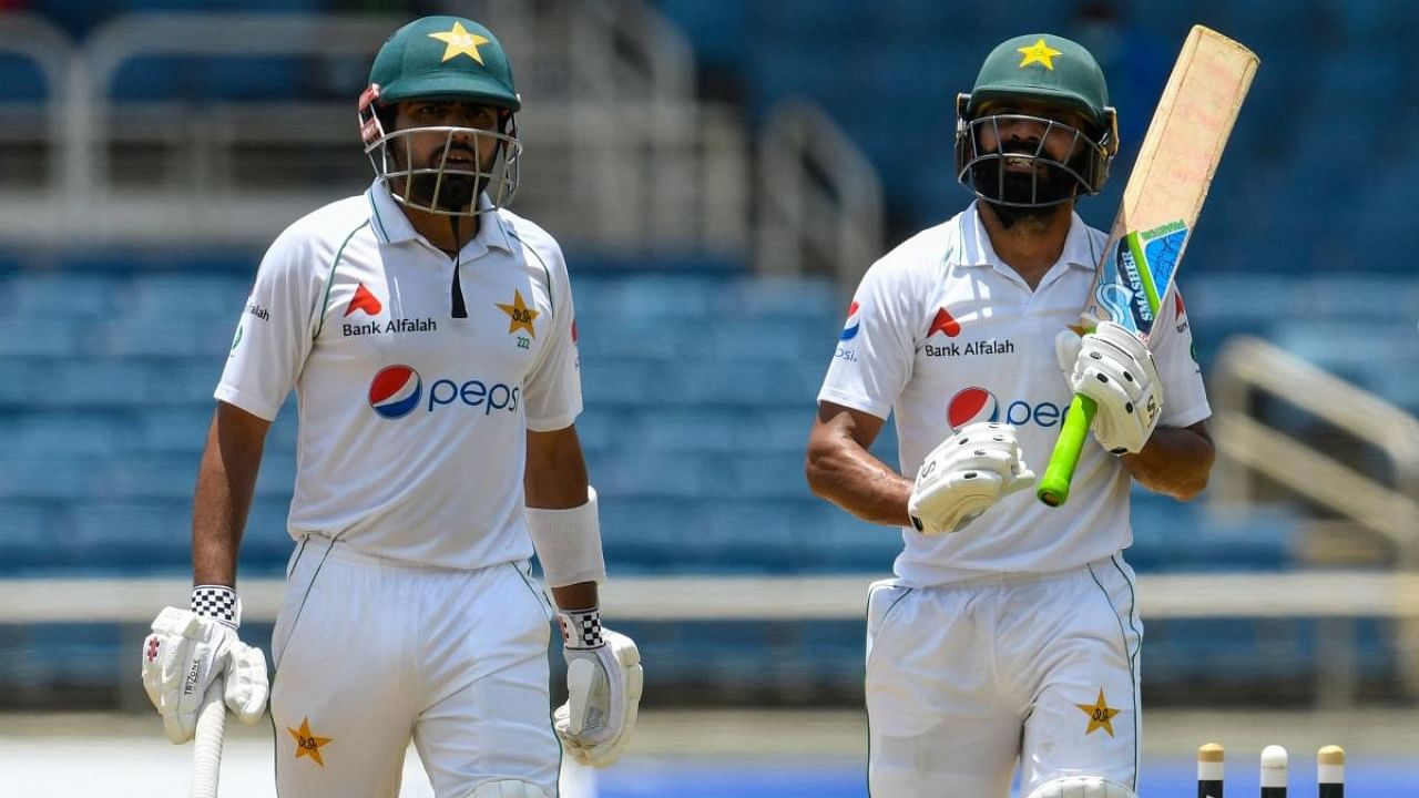 Babar Azam (L) and Fawad Alam (R) of Pakistan walks off the field for the lunch break during day 1 of the 2nd Test between West Indies and Pakistan at Sabina Park, Kingston, Jamaica. Credit: AFP Photo