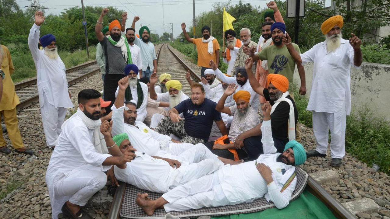  Farmers block railway tracks during their indefinite protest demanding higher sugarcane State Advisory Price (SAP), in Jalandhar. Credit: PTI Photo