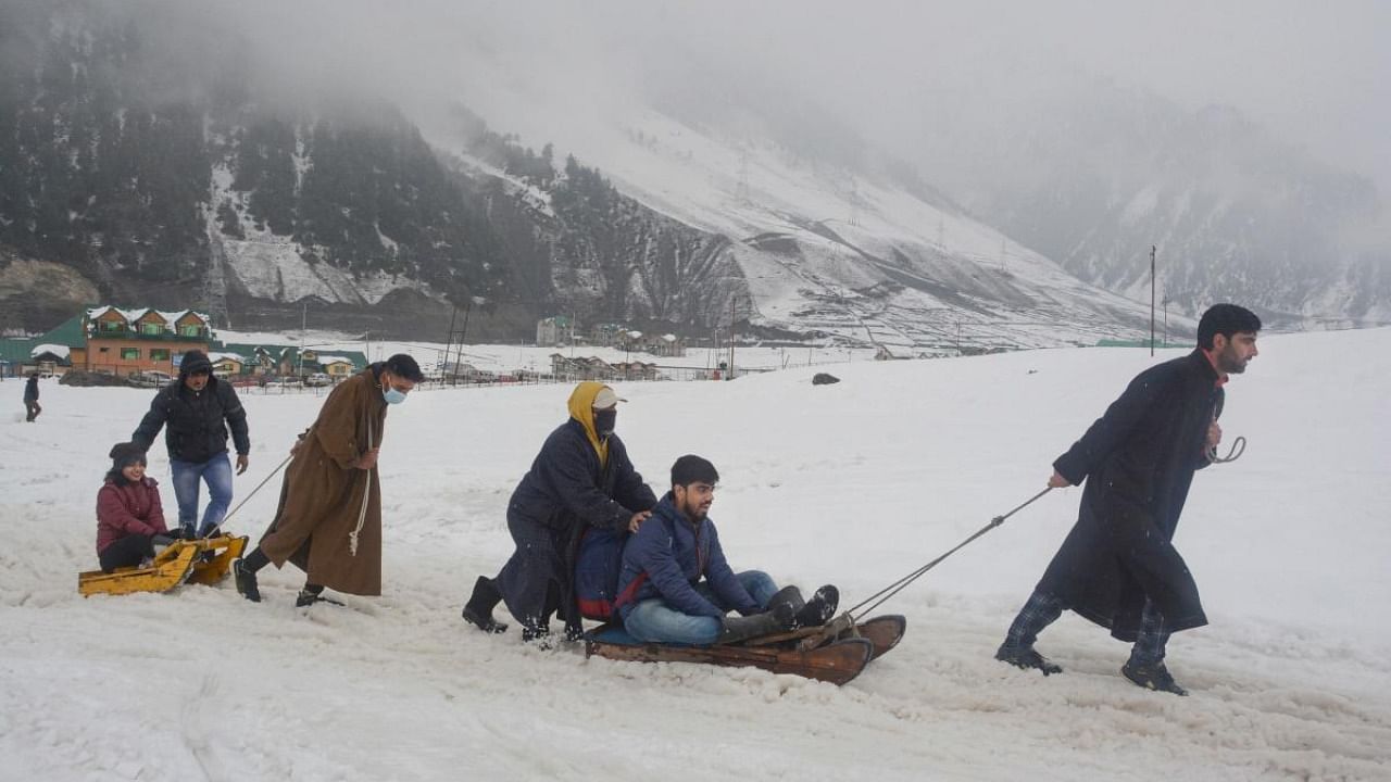 Tourists take a sledge ride after fresh snowfall during Sonamarg Winter Festival at Sonamarg in Ganderbal district. Credit: PTI Photo