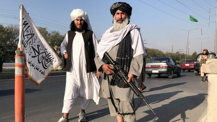 A Taliban fighter holding an M16 assault rifle stands outside the Interior Ministry in Kabul. Credit: Reuters File Photo