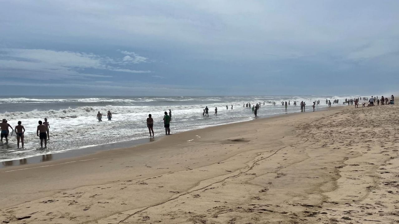 Residents and holiday makers in the Hamptons make the most of the calm before the storm at Atlantic Avenue beach ahead of Hurricane Henri's landfall, Long Island, New York, US. Credit: Reuters Photo