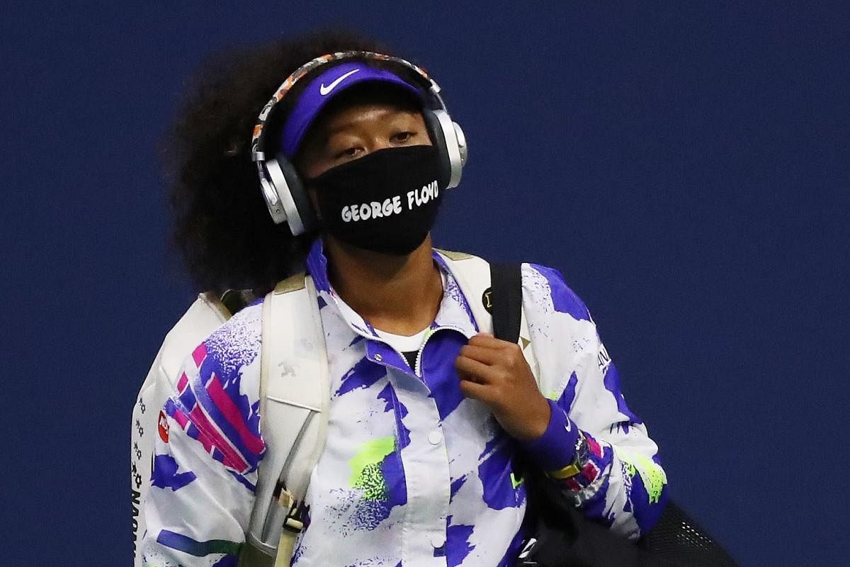 Naomi Osaka of Japan walks in wearing a mask with the name of George Floyd on it. Credit: AFP Photo