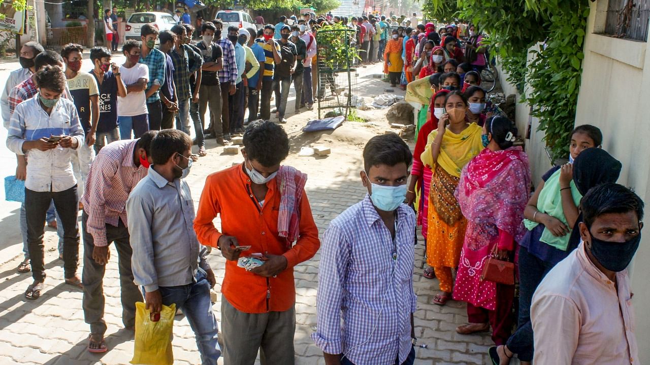 : Beneficiaries wait to receive a dose of Covid-19 vaccine at a vaccination centre in Gurugram. Credit: PTI File Photo