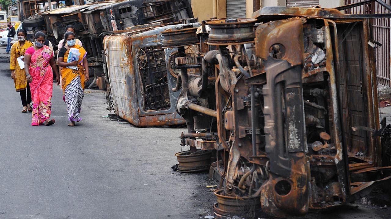 Rioters torched dozens of parked vehicles, buildings and other valuables in DJ Halli and KG Halli areas of East Bengaluru on August 11, 2020. Credit: DH Photo/PUSHKAR V